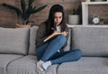 Book, writing and woman on sofa for thinking, journal and creative, brainstorm and notes in a living room. Notebook Royalty Free Stock Photo