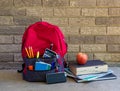 Bookbag With School Asseccories and Stack of Books Royalty Free Stock Photo