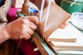 Bookbinding. Male worker binding pages.