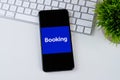 Booking.com app logo on a smartphone screen.