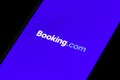 Booking.com logo displayed on the smartphone