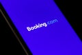 Booking.com logo displayed on the smartphone