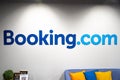 Booking.com logo on a white wall of an office
