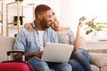 Booking Tour. African-American Couple Using Laptop At Home Royalty Free Stock Photo