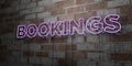 BOOKINGS - Glowing Neon Sign on stonework wall - 3D rendered royalty free stock illustration Royalty Free Stock Photo