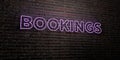 BOOKINGS -Realistic Neon Sign on Brick Wall background - 3D rendered royalty free stock image