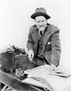 Bookkeeper with adding machine and pencil in his mouth