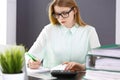 Bookkeeper or financial inspector woman making report, calculating or checking balance. Audit and tax service concept Royalty Free Stock Photo