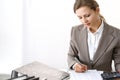 Bookkeeper woman or financial inspector making report, calculating or checking balance. Business portrait. Copy spac