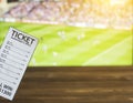 Bookmaker ticket on the background of TV on which show Gaelic football, sports betting, bookmaker