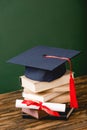 Books, academic cap and diploma on wooden surface Royalty Free Stock Photo