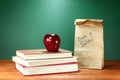 Books, Apple and Lunch on Teacher Desk Royalty Free Stock Photo