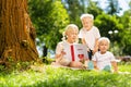 Attentive children reading a book in the park