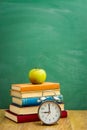 Books on the background of the school board Royalty Free Stock Photo