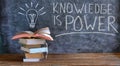 Knowledge is power, books and blackboard with drawing of a lightbulb,education,learning,reading,knowledge,back to school concept. Royalty Free Stock Photo