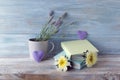 Books with bookmarks of fresh flowers, hearts, lavender bouquet on wooden table