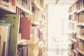 Books in the bookshelf. Public library or university, books in the blurry background Royalty Free Stock Photo