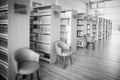 The books on bookshelf and purple chairs in interior library of University