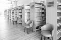 The books on bookshelf and purple chairs in interior library of University