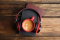 Books, coffee and headphones on wooden table, top view