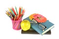 Books, colored pencils, glasses and a green apple isolated on a white background Royalty Free Stock Photo