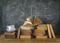 Books, cup of coffee, blackboard, diagram Royalty Free Stock Photo