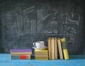 Books, cup of coffee, blackboard, diagram Royalty Free Stock Photo