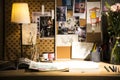 Books and drafts on wooden table under lamp light