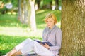 Books every girl should read. Girl concentrated sit park lean tree trunk read book. Reading inspiring books. Bestseller Royalty Free Stock Photo