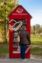 Books exchange point in the Glinianki park near Warsaw, a woman standing in front of a booth