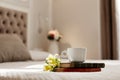 Books, flowers, and a coffee Cup lie on the bed. Romantic gift, romantic message, coffee in bed Royalty Free Stock Photo