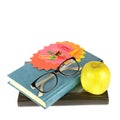 Books, glasses and a green apple isolated over a white . Free space for text