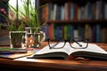 Books and glasses on a wooden desk create a study scene