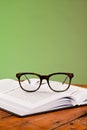 Books and glasses on a wooden table