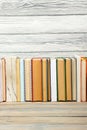 Books on grunge wooden table desk shelf in library. Back to school background with copy space for your ad text. Old Royalty Free Stock Photo