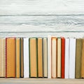 Books on grunge wooden table desk shelf in library. Back to school background, copy space for your ad text. Old hardback Royalty Free Stock Photo