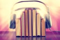 Books and headphones as an audiobook concept on a wooden table