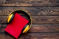 Books with headphones for listening to audiobook on wooden background top view copy space Royalty Free Stock Photo