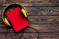 Books with headphones for listening to audiobook on wooden background top view copy space Royalty Free Stock Photo