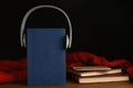 Books, headphones and mobile phone on table. Space for text