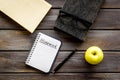 Books for homework on dark wooden student desk top-down