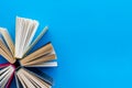 Books on library desk for reading and education on blue background top view mockup