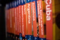 Books of the Lonely Planet series on the bookcase with only the book of Andalucia in focus Royalty Free Stock Photo