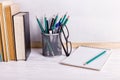 Books, markers, notebook, pencil and glasses on the table against the background of a white board. Copy space Royalty Free Stock Photo