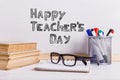 Books, markers, notebook, pencil and glasses on the table against the background of a white board. Copy space Royalty Free Stock Photo