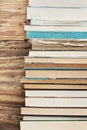 Books next to the wooden wall Royalty Free Stock Photo