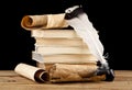 Books, old paper and feather in an inkwell isolated on a black background Royalty Free Stock Photo