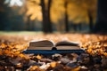 Books open on a log surrounded by vibrant fall foliage, diverse education and teachers day image