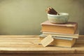 Books and pencils on wooden table in vintage style