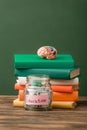 Books, piggy bank and brain on wooden surface Royalty Free Stock Photo